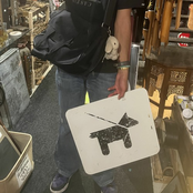 Holding the dog sign