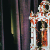 A Statue In Front Of The Devil
