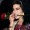 Amy Winehouse receives flowers on stage