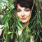 A smiling Kate Bush and plants