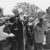 Bobby Casey with John Kelly junior and senior at the graveside memorial for Willie Clancy