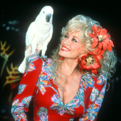 american-singer-and-songwriter-dolly-parton-poses-with-a-news-photo-1574715279.png