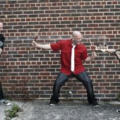 Guitar Warriors vs Grand Master Sticks