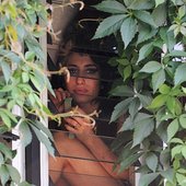 Amy Winehouse looks out the window of her North London home, June 11, 2008.