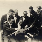 Leroy Smith and his orchestra posing in front of piano with sheet music-crop.jpg