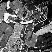 Sam from Ranganasher laying on the floor during a live show in Brighton UK