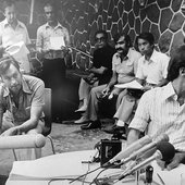 Rashid Khalidi, right, “helping out at a press briefing at the Commodore Hotel, Beriut,” 1982. (Abdallah El-Binni, Al-Jazeera.)