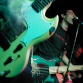 close up on one of the guys' guitar (live in color)