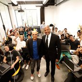 Jimmy Iovine and Dr. Dre stand in a classroom with students at the USC Iovine and Young Academy