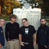 in front of a sign for elvis