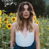 bre standing in a field of sunflowers