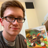 Scott holding a copy of Donkey Kong Barrel Blast