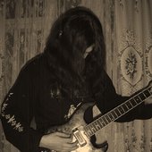 Hastner playing on old guitar