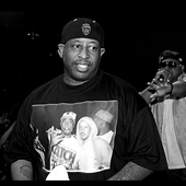 DJ Prem wearing a picture of Guru and Tupac. 