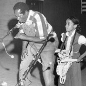 Abner with girl playing bones at the Florida Folk Festival