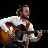 Naftali Kempeh with guitar and kippah