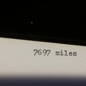 7697 Miles logo