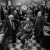 Studio 317, one of four composition studios at the C-PEMC, circa 1970. Clockwise from the center front, Vladimir Ussachevsky (seated), Milton Babbitt, Bülent Arel, Pril Smiley, Mario Davidovsky, Alice Shields, Otto Luening.