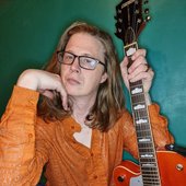Jon Mckenzie posing with his guitar
