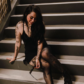 dangerousbeauty sitting on stairs with sunglasses.png