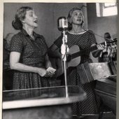 Joan O'Bryant (right) and another performer recording the 1958 Arkansas Folklore Society Annual Meeting during a performance in Prairie Grove, Arkansas.-14207061796