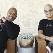 Jimmy Iovine and Dr. Dre sitting in patio lounge chairs