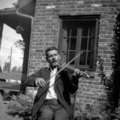 Ed Morrison playing stringed instrument outside.jpg