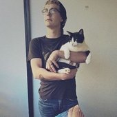 the man himself, holding a very thick cat