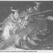 Siona Shaman playing wire-stringed bow.png