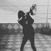 Dettune swinging an acoustic guitar