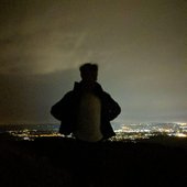 owen silhouette with city lights in back