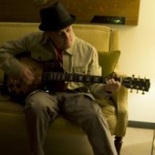Playing guitar.