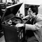 Nam June Paik demonstrates Listening to Music through the Mouth in Exposition of Music Electronic Television, 1963