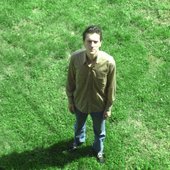tyler_baum_standing_in_a_field_looking_up.jpg