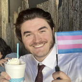 The Schlatt holding a trans-flag