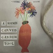 A HAND CARVED GARDEN TOOL