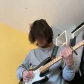 Kai playing guitar (from Bandcamp)