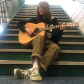 angel at school stairwell with guitar