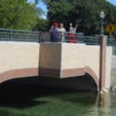 4 on bridge waving