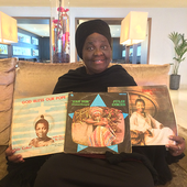 Julie Coker holding her three albums