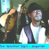 tom ketchfish with pile of guitars