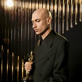 Daniel Blumberg with his Oscar for The Brutalist
