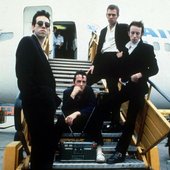 The Clash landing in New York, before playing at Bond's in New York Times Square.