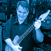 aubrey_posing_with_his_brian_moore_custom_guitar_portrait.png